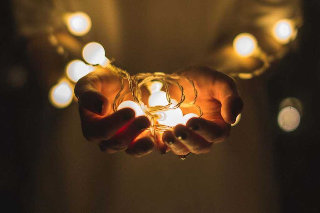 2264616-0-12739200-1740560541-idea_lights_lightbulbs_hands_by_josh_boot_cc0_via_unsplash_1200x800-100763485-orig-100935639-orig-1 hands hold a string of lightbulbs hands at sunset / ideas / brainstorming / invention / innovation