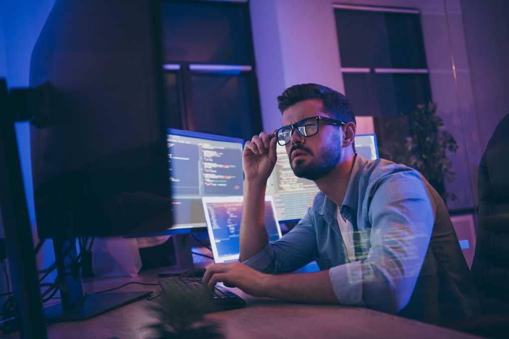 3619159-0-89368000-1733528452-software_development_lifecycle_developers_programmers_coding_code_by_roman_samborskyi_shutterstock_1536573386_royalty-free_digital-only_2400x1600-100890352-orig-1 Profile photo of a developer / programmer reviewing code on monitors in his workspace.