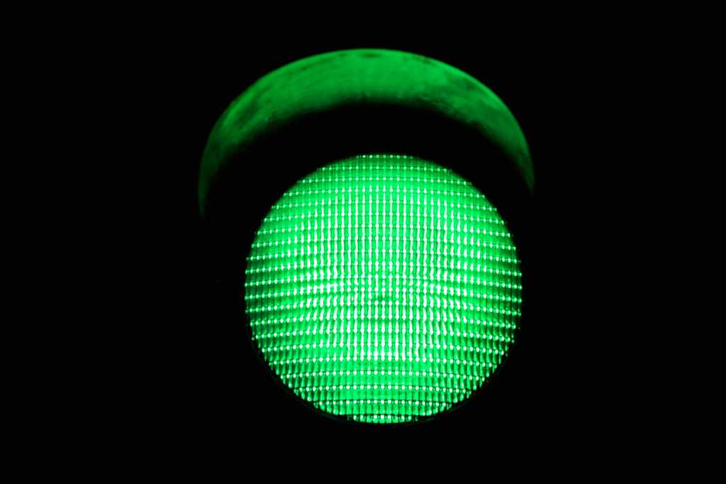 3842456-0-75838700-1741705264-shutterstock_40663132-100942528-orig-1 shutterstock 40663132 green traffic light on black background