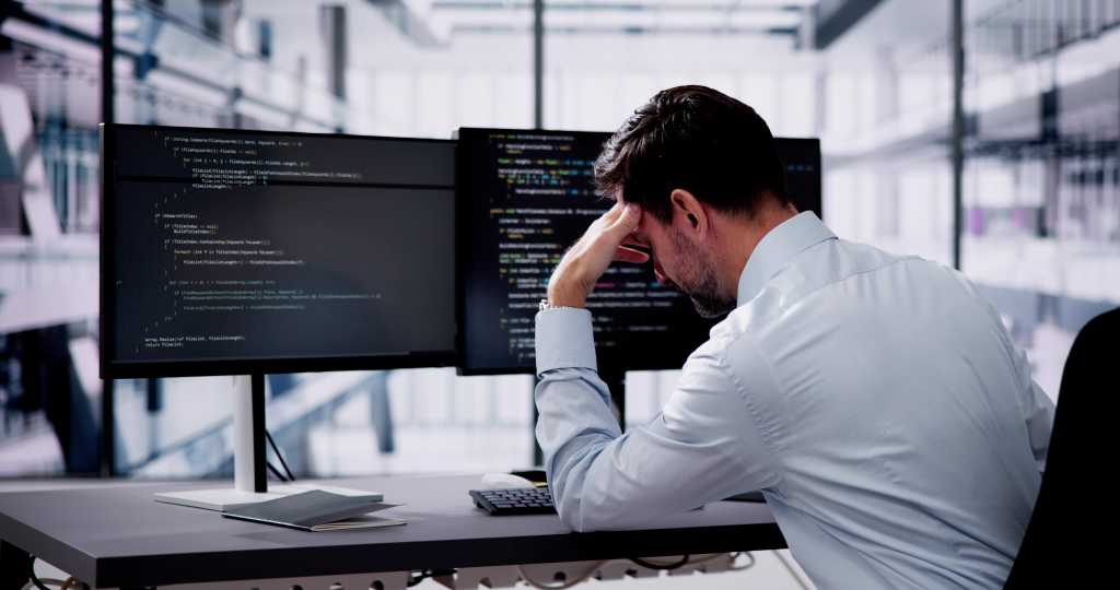 3844363-0-39941100-1742313528-shutterstock_2418299973-1-1 Unhappy Sad Developer Programmer Man In Stress Coding Software On Computer