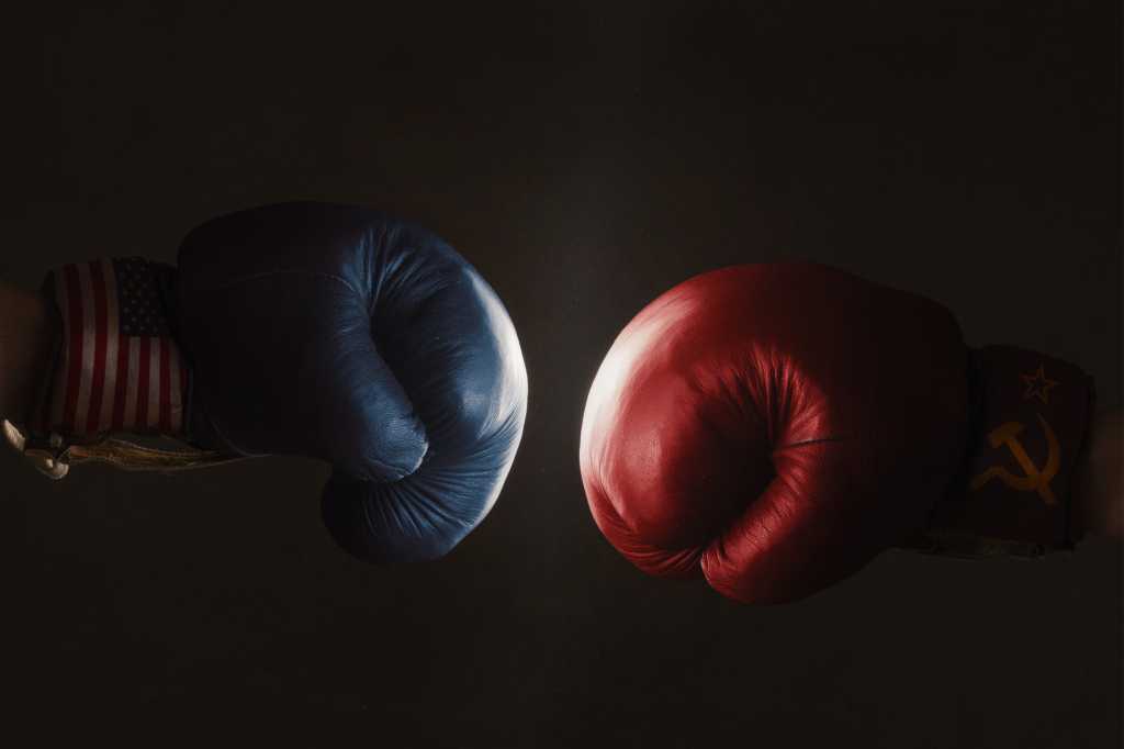 3962924-0-65255000-1744794078-shutterstock_347074193-1 blue and red boxing gloves face off against a black background