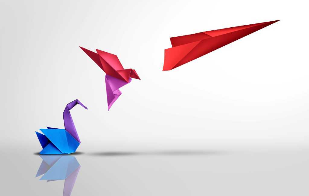3963991-0-60640300-1745485313-shutterstock_2275464667-1 Paper cranes, change, evolution. A colorful paper crane becomes a paper airplane in flight.