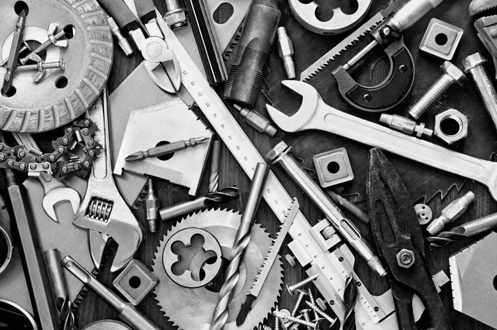 3973973-0-83007700-1745963266-shutterstock_175644863-100940898-orig-1 shutterstock 175644863 scattered clutter of nuts bolts wrenches tools in black and white