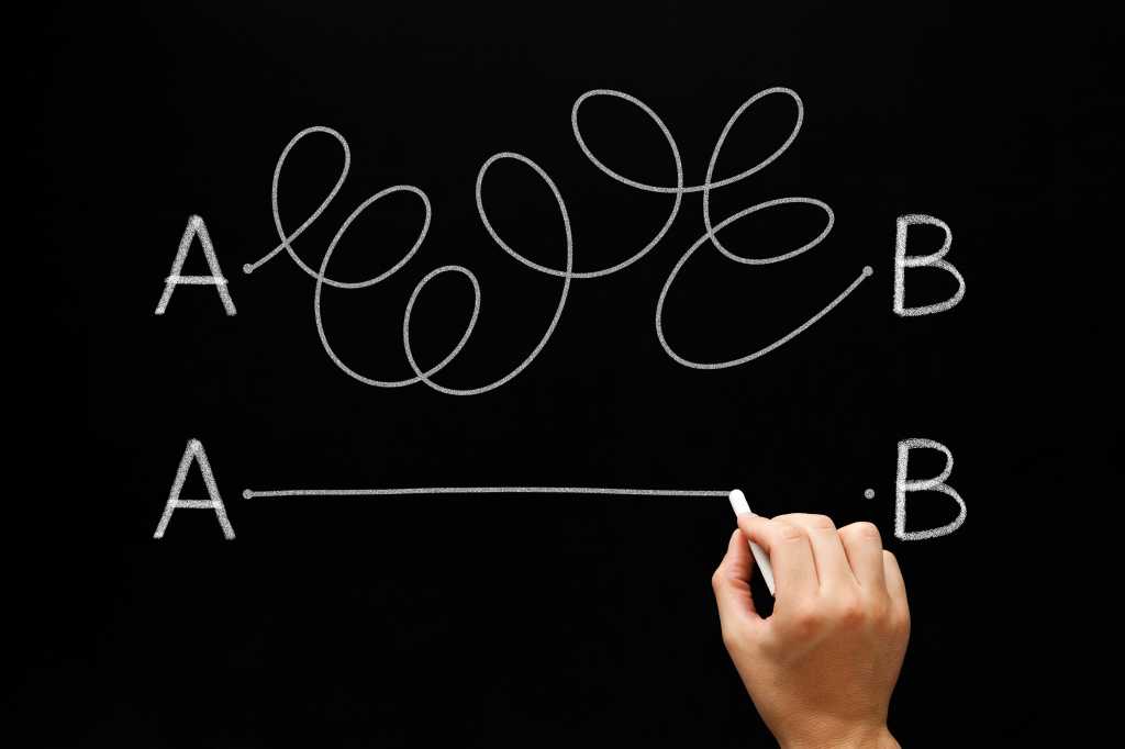 3973790-0-11975400-1746608469-shutterstock_2257445733-1 Hand drawing a white chalk line from point A to point B on a blackboard.