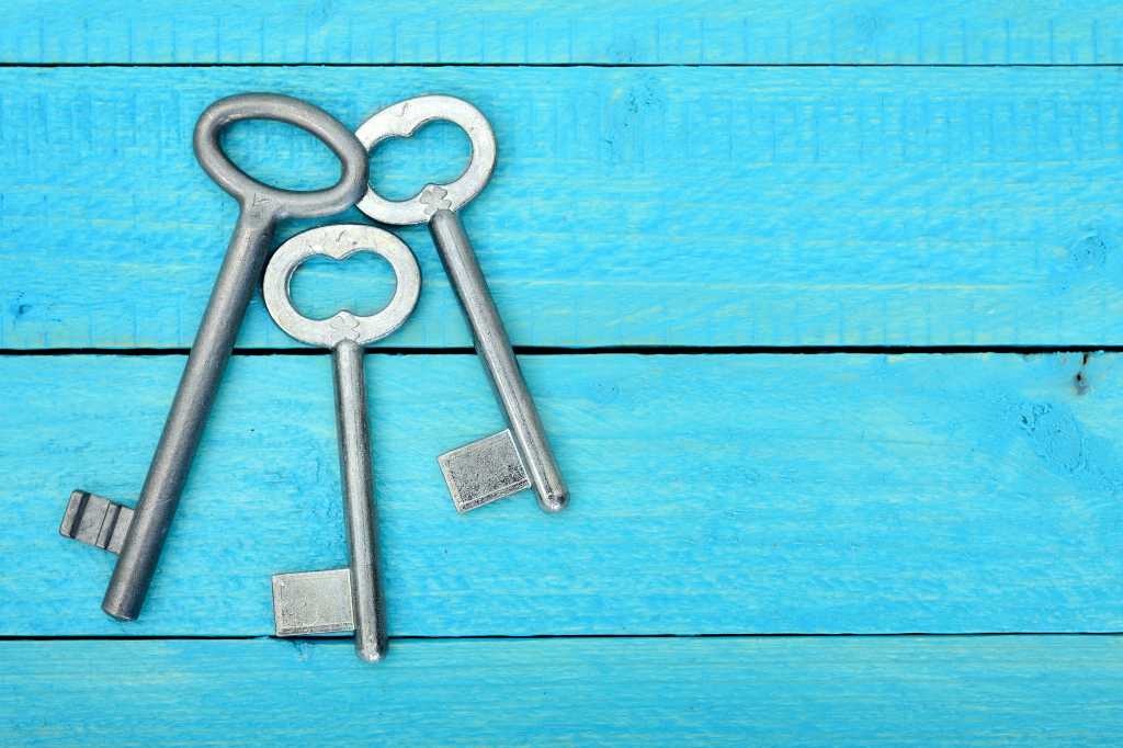 4000371-0-36628100-1748977600-shutterstock_484887943-1 Top view of three 3 keys on a wooden blue table