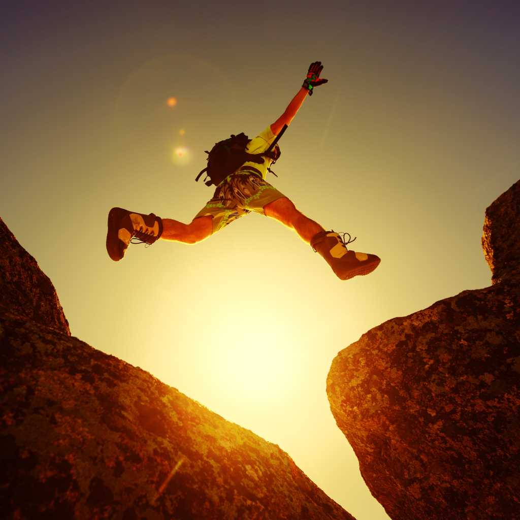 4003278-0-67277600-1749255267-shutterstock_359951588-100939095-orig-1 Leap, jump, risk, adventure. A person leaping between two boulders.