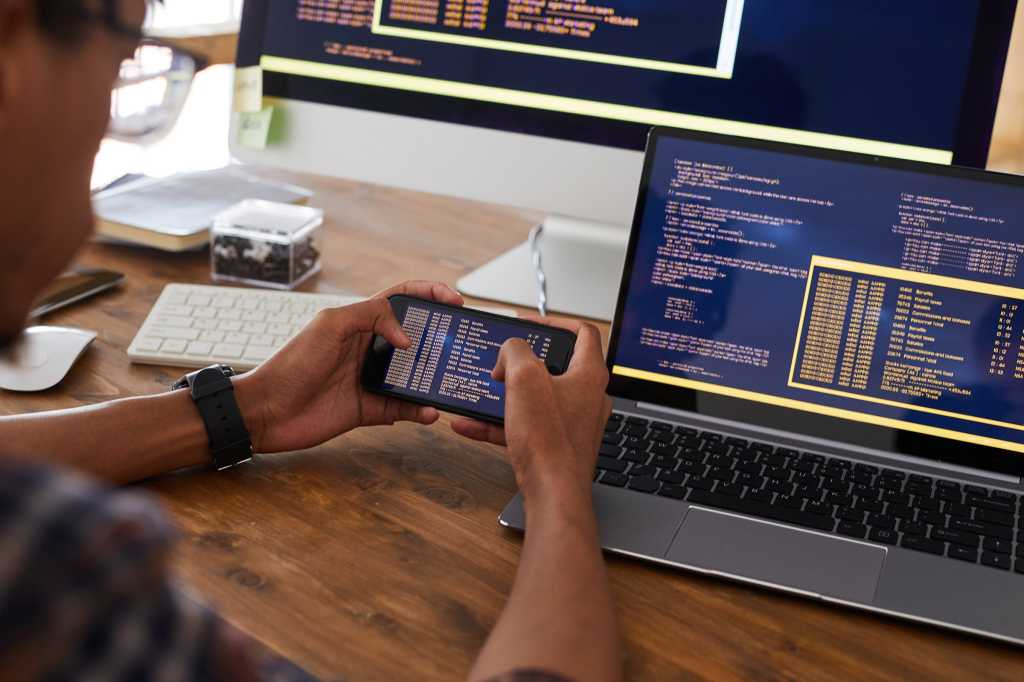 4007011-0-29256800-1749851398-software_development_lifecycle_developers_programmers_coding_code_by_seventyfour_shutterstock_1774612583_royalty-free_digital-only_2400x1600-100890353-orig-1 A developer / programmer reviews code on mobile phone, laptop, and desktop displays.
