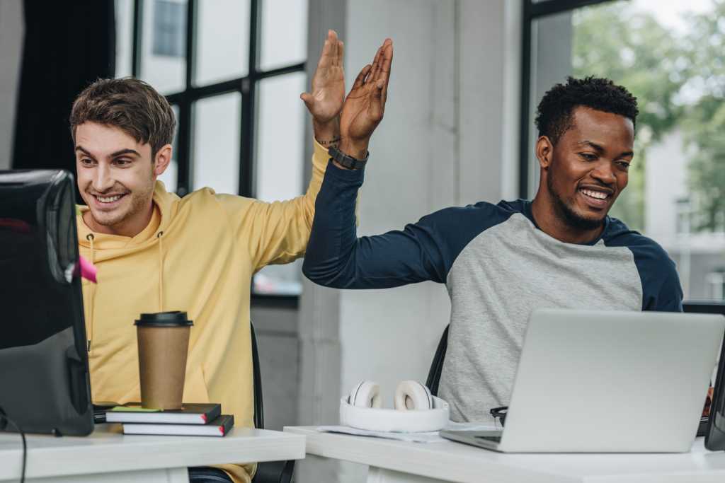 4008535-0-82482900-1750237372-shutterstock_1500472583-1 happy multicultural programmers giving high five while working in office together